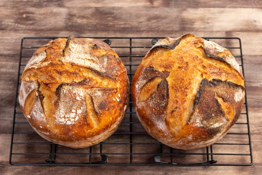 Freshly baked artisan sourdough bread loaves on a wooden board.