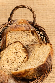 Close up of hearty artisan sourdough bread slices in a bread basket.