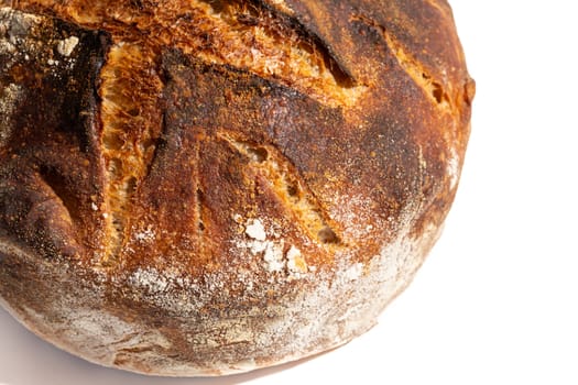 Close up of freshly baked artisan sourdough bread loaf isolated on white.