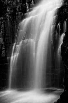 Beautiful and powerful waterfall flowing down cliff ledge