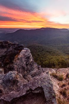 Red sunrise over the Blue Mountains cliffs and valleys.  Vertical format