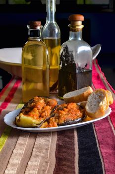 Plate of aubergines stuffed with cod and three types of olive oil