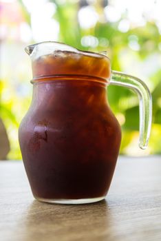 Iced coffee on the wooden table in coffee cafe.