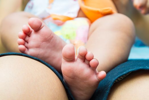 Baby feet in mother's hands