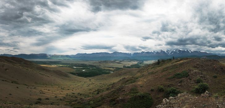 Panoramic picture of Kurai steppe and North-Chui ridge of Altai mountains, Russia. Cloud day.