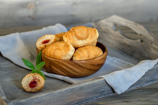 Croissants on a wooden tray. The concept of a wholesome breakfast
