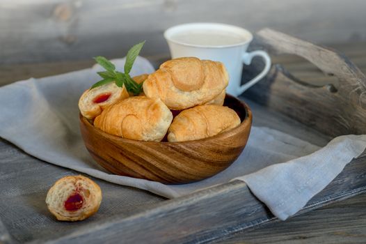 Croissants on a wooden tray. The concept of a wholesome breakfast
