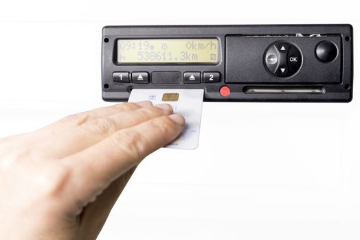Digital tachograph and drivers hand inserting drivers card in it. No personal data. Isolated on white background.