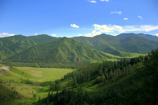 Green fertile valley surrounded by high hills. Altai, Siberia, Russia