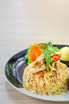 fried rice with pork served with fresh vegetable