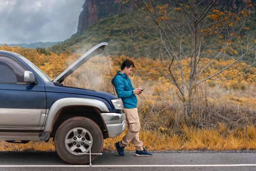 Motorist Broken Down On Country Road Phoning For Help