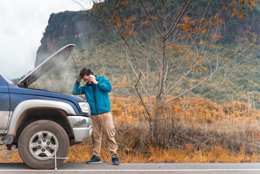 Motorist Broken Down On Country Road Phoning For Help