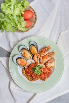 Spaghetti with seafood in tomato sauce on a plate