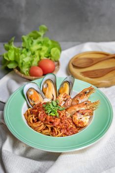 Spaghetti with seafood in tomato sauce on a plate