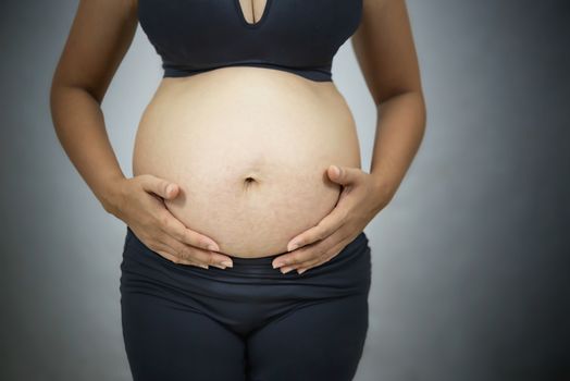 Close up  of pregnant  asian woman in black underwear