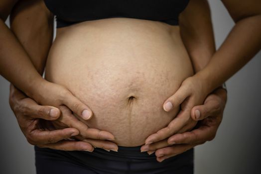 Close up  of pregnant  asian woman in black underwear