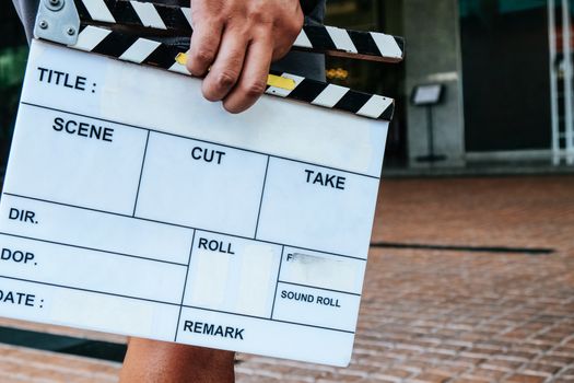 Filming crew,Man hands holding movie clapper.