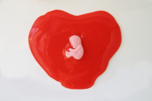 embryo doll on red jelly.