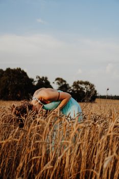 Beautiful Young Woman Dancing In The Field at sunset