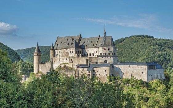 The old and restored Vianden castle on a blue sky background , Luxembourg, Europe