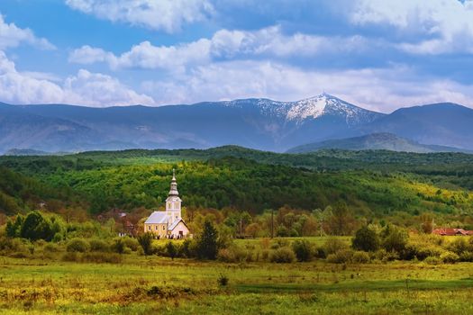 Church in front of Carpathian Mountains in Romania