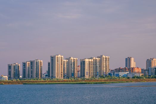 Urban landscape of commuter town on river bank in Kazan, Russia