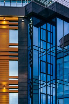 Modern high-rise office building with a glass facade, background.