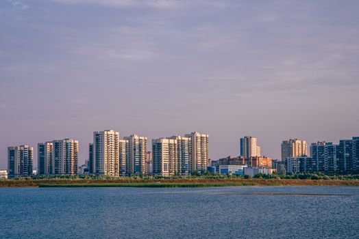 Urban landscape of commuter town on river bank in Kazan, Russia