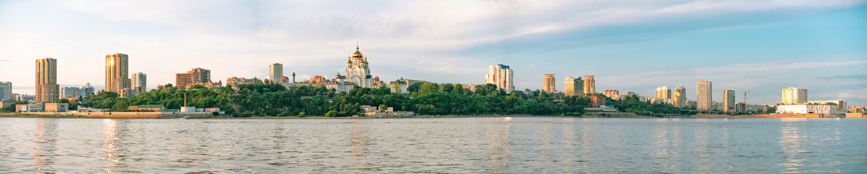 View of the city of Khabarovsk from the Amur river. Urban landscape in the evening at sunset