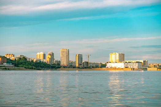 View of the city of Khabarovsk from the Amur river. Urban landscape in the evening at sunset
