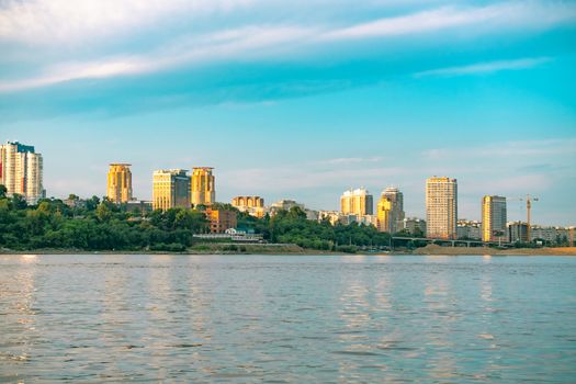 View of the city of Khabarovsk from the Amur river. Urban landscape in the evening at sunset