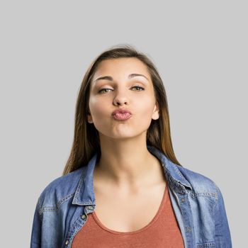 Portrait of a beautiful woman sending a kiss