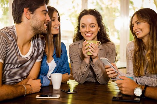 A group of friends talking and drinking coffee at the cafe