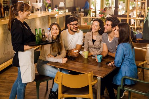 A group of friends making a order at cafe 