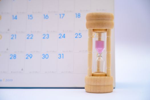 Hourglass with calendar ideas days elapsed time in each period and appointments or waiting
