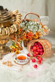 Russian traditional water boiler, flowers and berries on a studio background