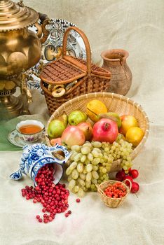 Russian traditional water boiler, flowers and berries on a studio background