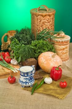 Vegetables, greenery and pumpkin on a studio background