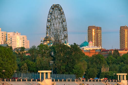 View of the city of Khabarovsk from the Amur river. Urban landscape in the evening at sunset