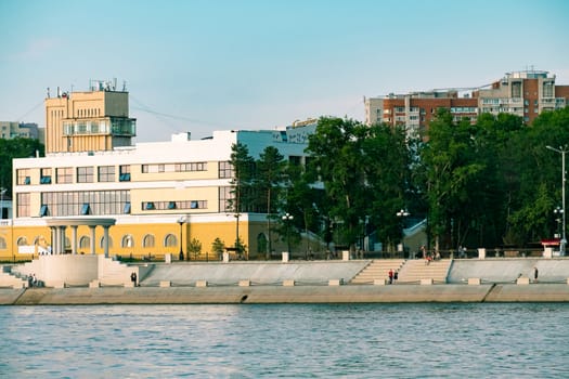 View of the city of Khabarovsk from the Amur river. Urban landscape in the evening at sunset