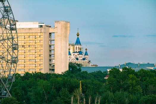 View of the city of Khabarovsk from the Amur river. Urban landscape in the evening at sunset