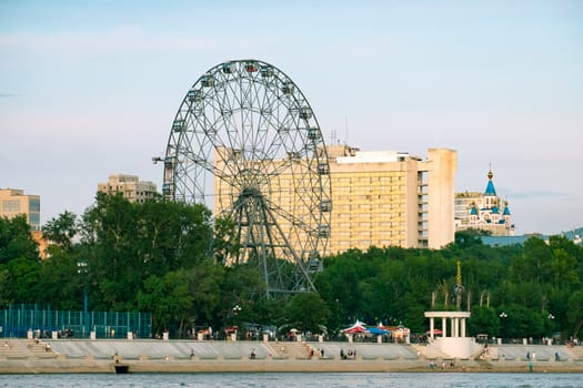 View of the city of Khabarovsk from the Amur river. Urban landscape in the evening at sunset