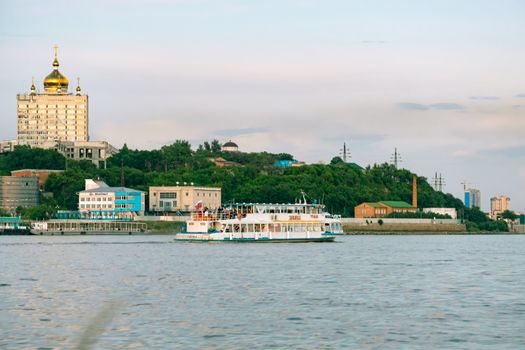 View of the city of Khabarovsk from the Amur river. Urban landscape in the evening at sunset