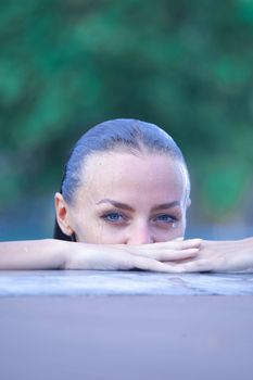 Portrait of a beautiful woman posing by the pool