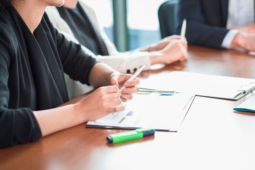 Business people discussing financial reports at meeting table