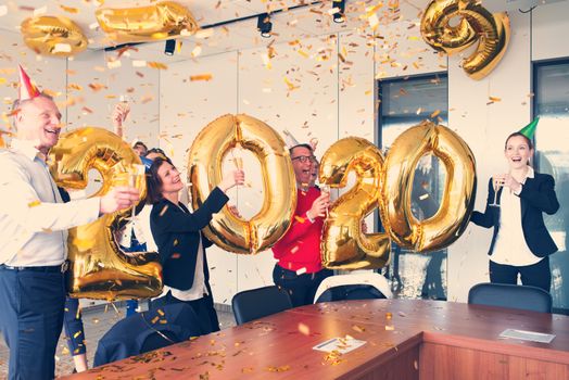 Business people celebrating 2020 New Year at office party