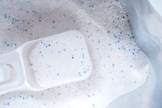 washing powder with measuring cup in a washing powder bag