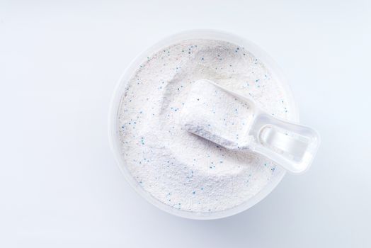 washing powder with measuring cup on a washing powder box isolated on white background