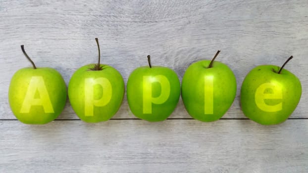 apples medium-sized green juicy lie on the wooden surface there is room for text