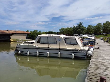 mini guide to France .The white pleasure yacht is parked at the river pier.